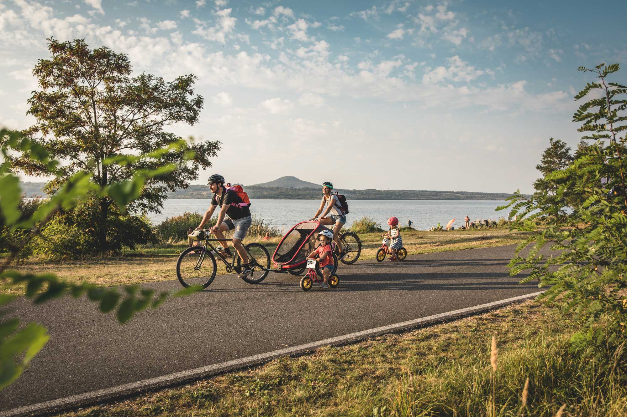 Eine Familie fährt Fahrrad an einem See